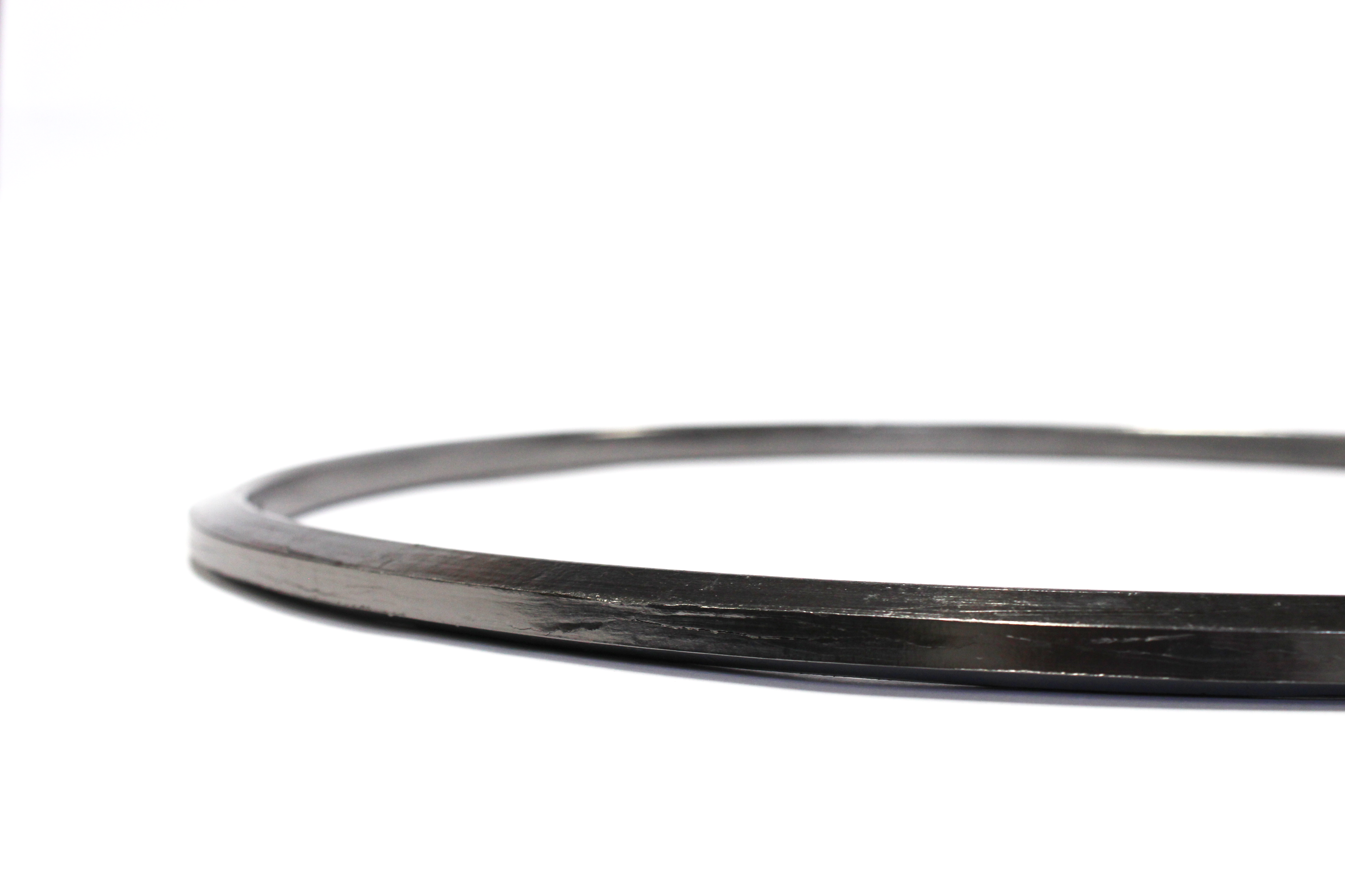 Close up side view of 1927181 graphite gasket on white background