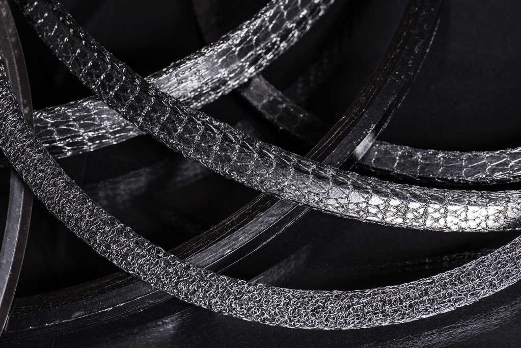close up of various gaskets including knitted wire mesh, graphite and wire bound graphite